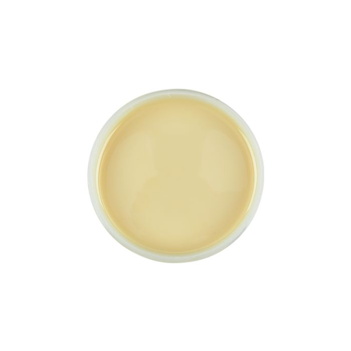 Top view of an open container of Satin Smooth beBare Hair Removal System Soy Wax featuring its creamy beige color